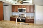 Kitchen With Raised Ceiling, Accent Lighting, & Ceiling Fan